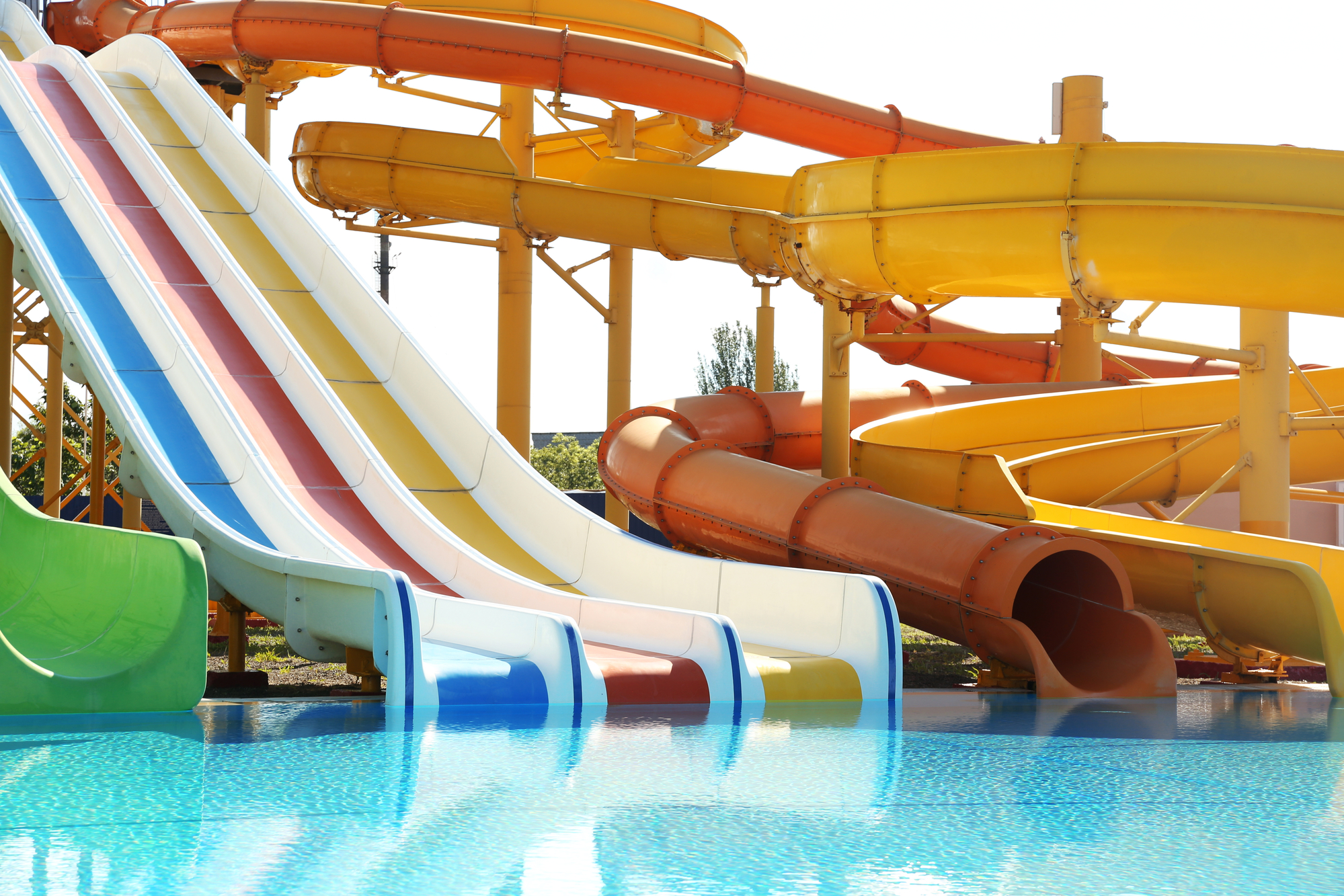 Different colorful slides in water park on sunny day